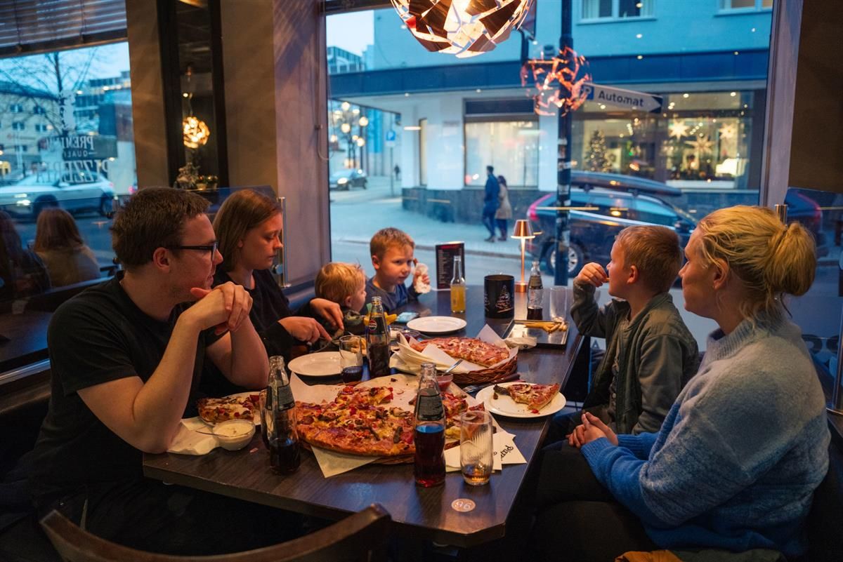 Familie som spiser pizza