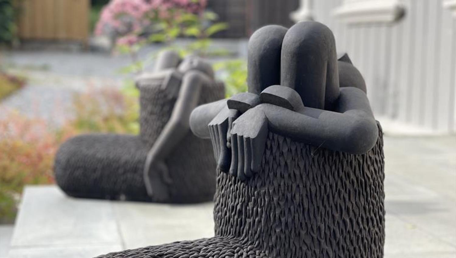 Black sculpture looing like boots