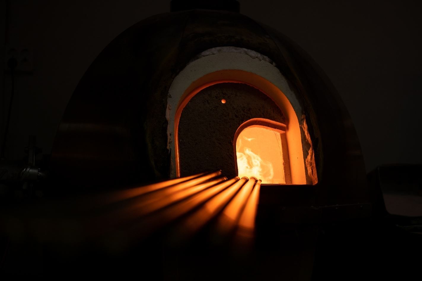 Glowing glass furnace at Blåst Glass Studio in Tromsø, where high temperatures are used to create handcrafted glass products.