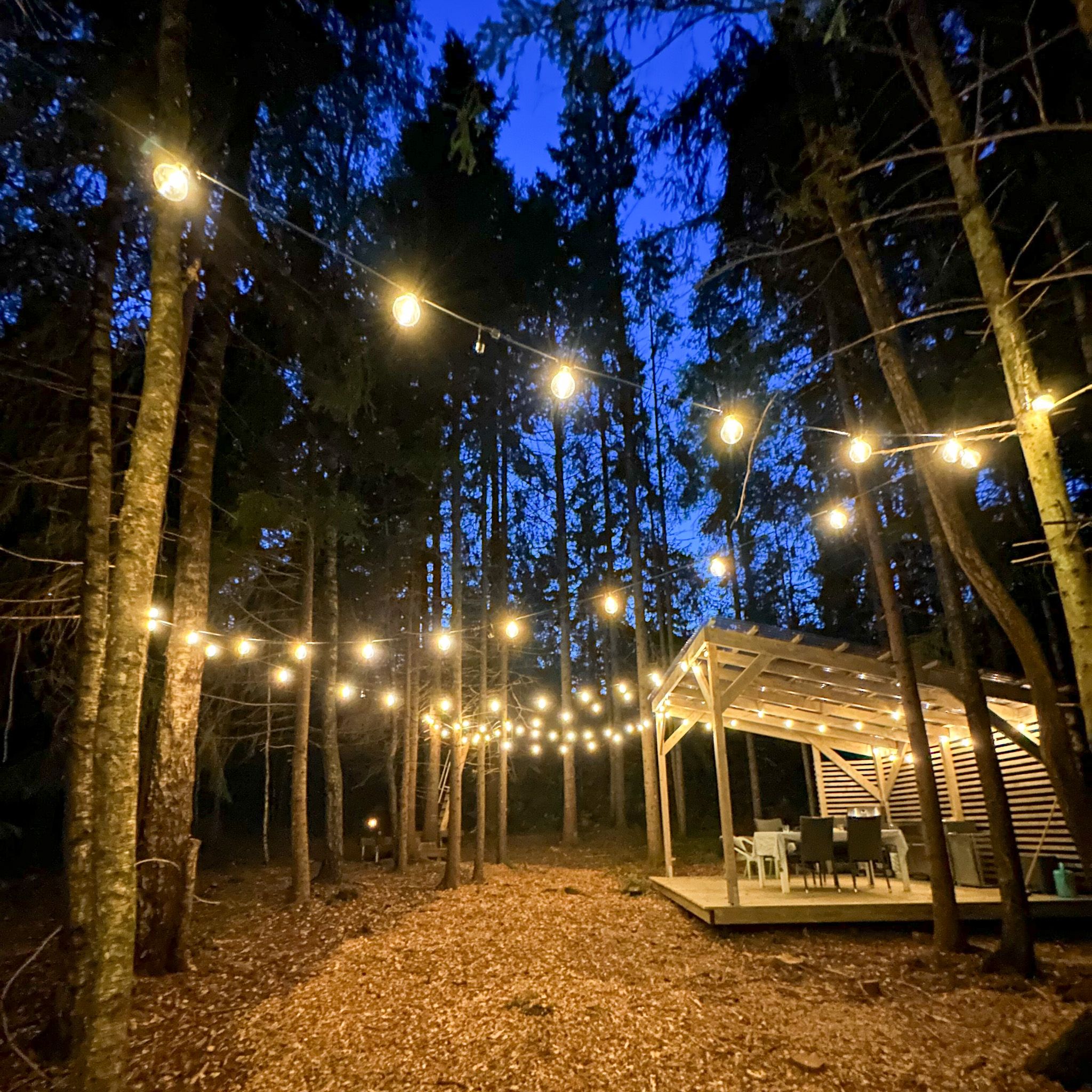 The outdoor space in the evening, with nice hanging lights