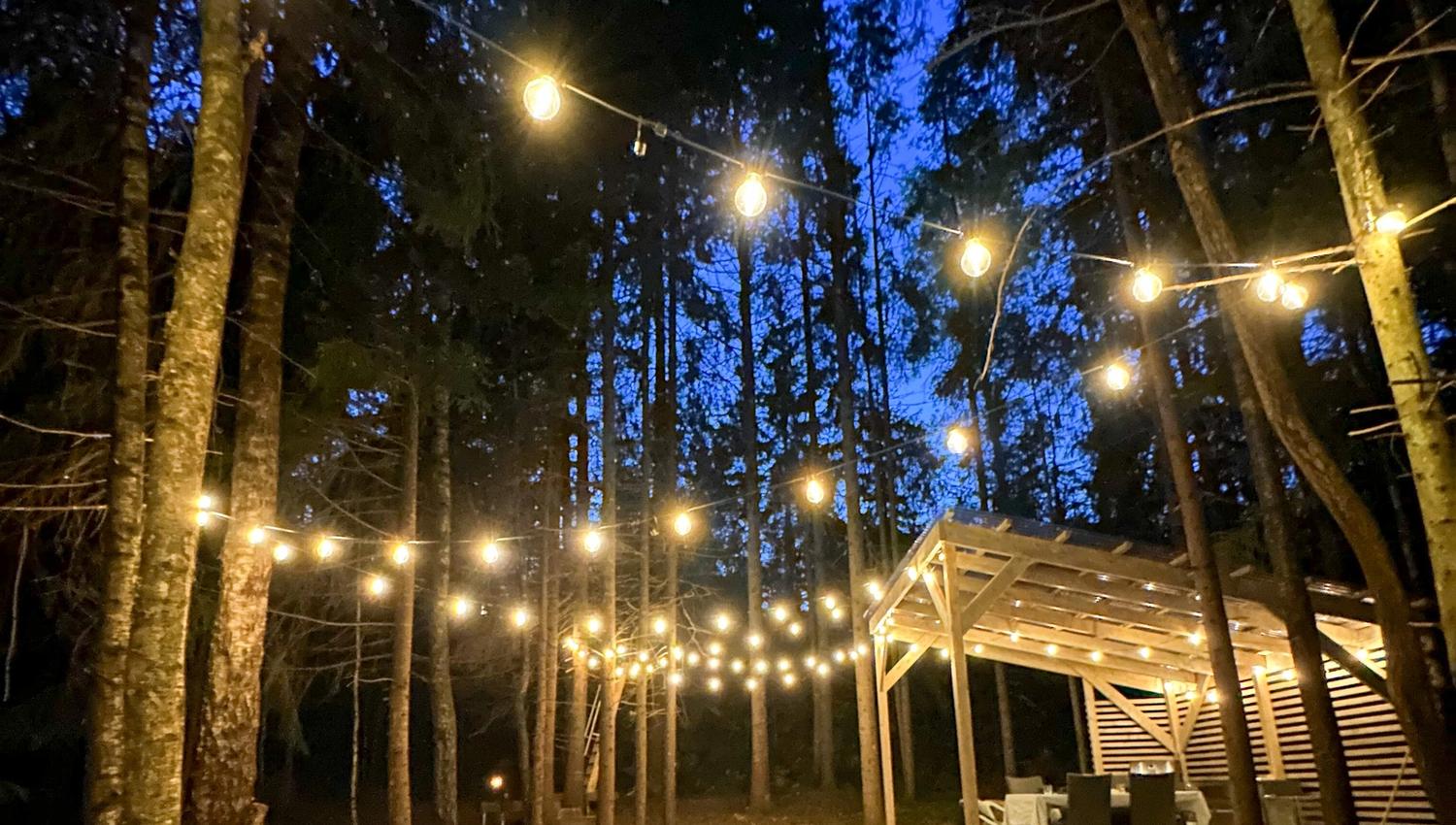 The outdoor space in the evening, with nice hanging lights