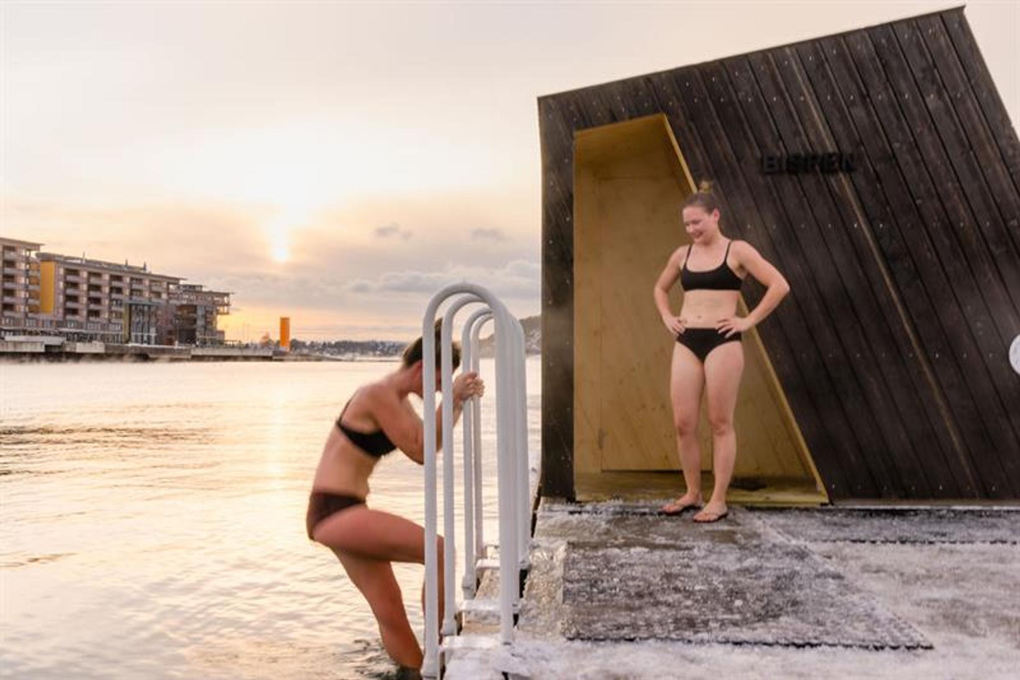 Two women bathing during winter