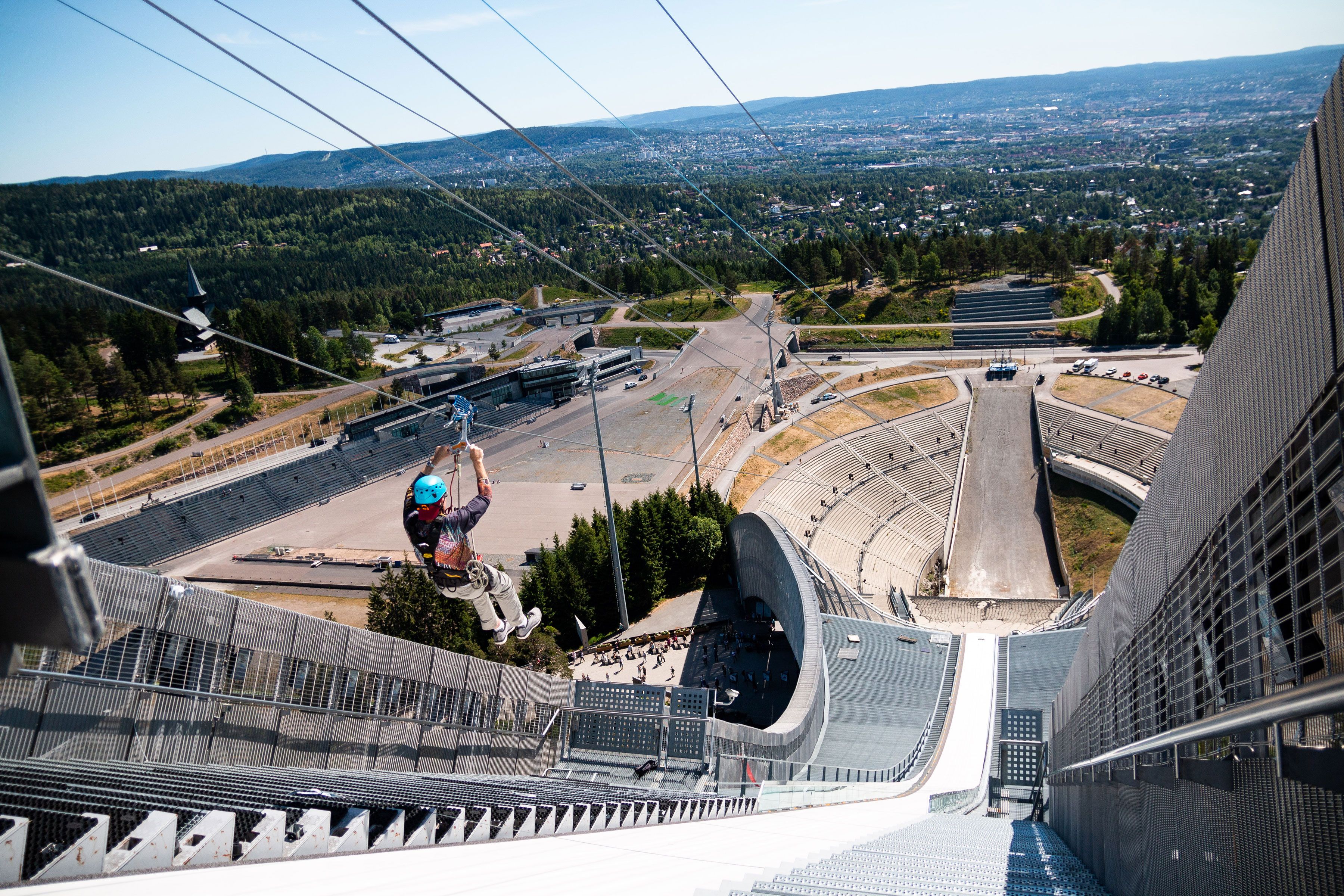 Person ziplining down Holmenkollen Ski Jump.