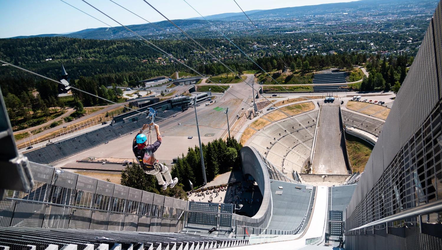 Person ziplining down Holmenkollen Ski Jump.