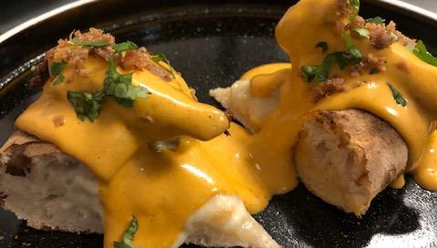 Detail of pizza with Butter Chicken topping.