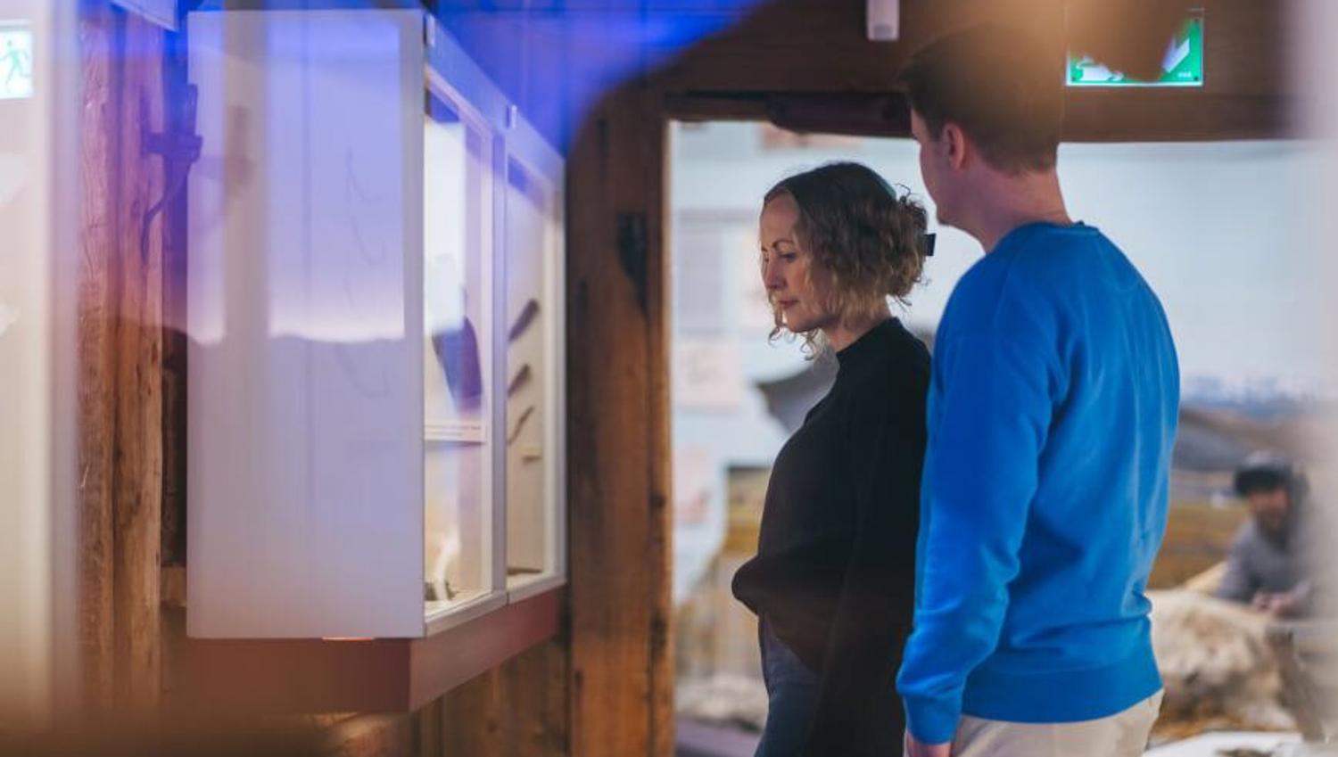 Two persons studying an exhibition at The Polar Museum in Tromso