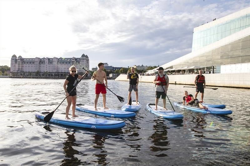 Five paddlers in front of the Opera House.
