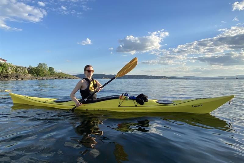 Girl paddling on the fjord