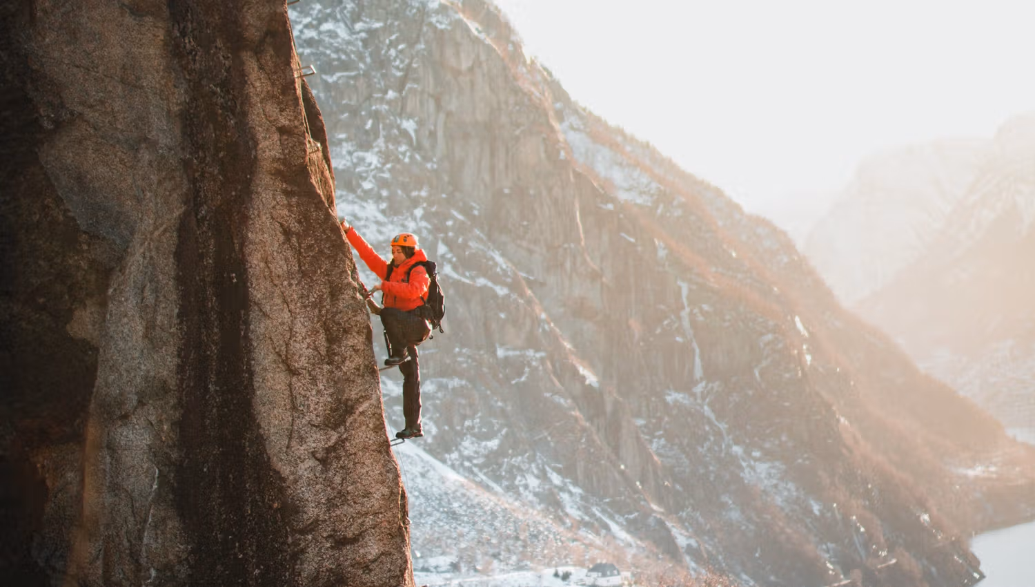Rest stop on Via Ferrata Tyssedal in autumn colors with fjord views.