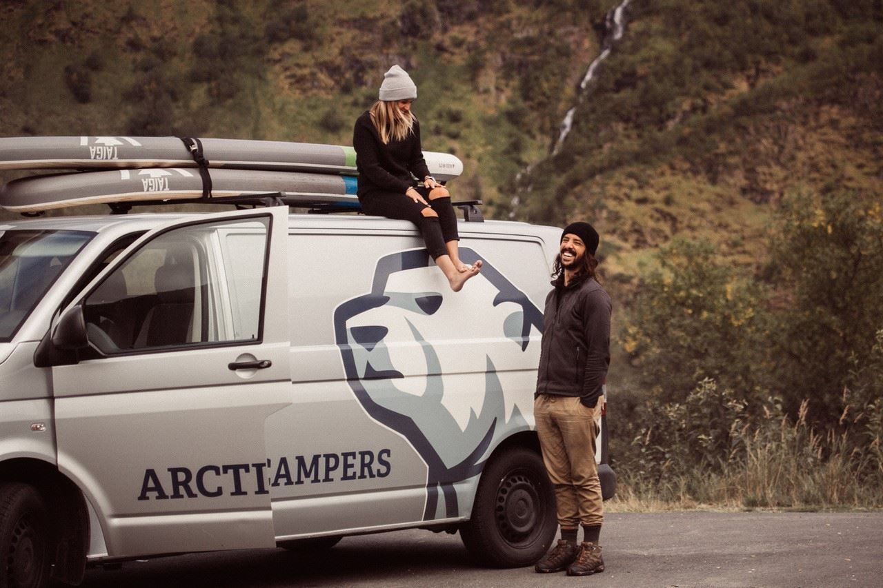 Two people by a camper van