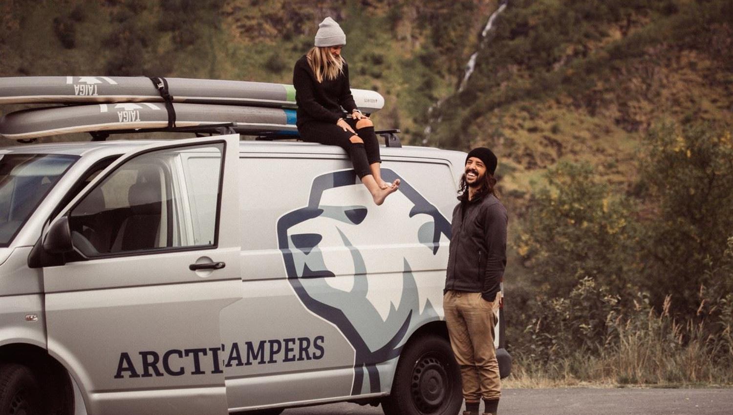 Two people by a camper van