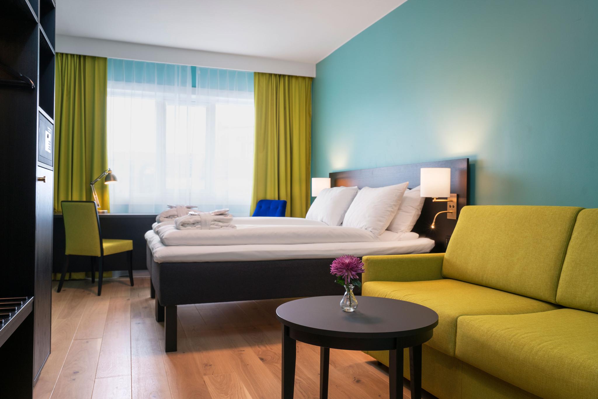 Colorful twin-room with bed, sofa, closet and desk