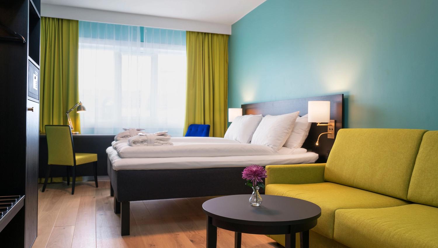 Colorful twin-room with bed, sofa, closet and desk