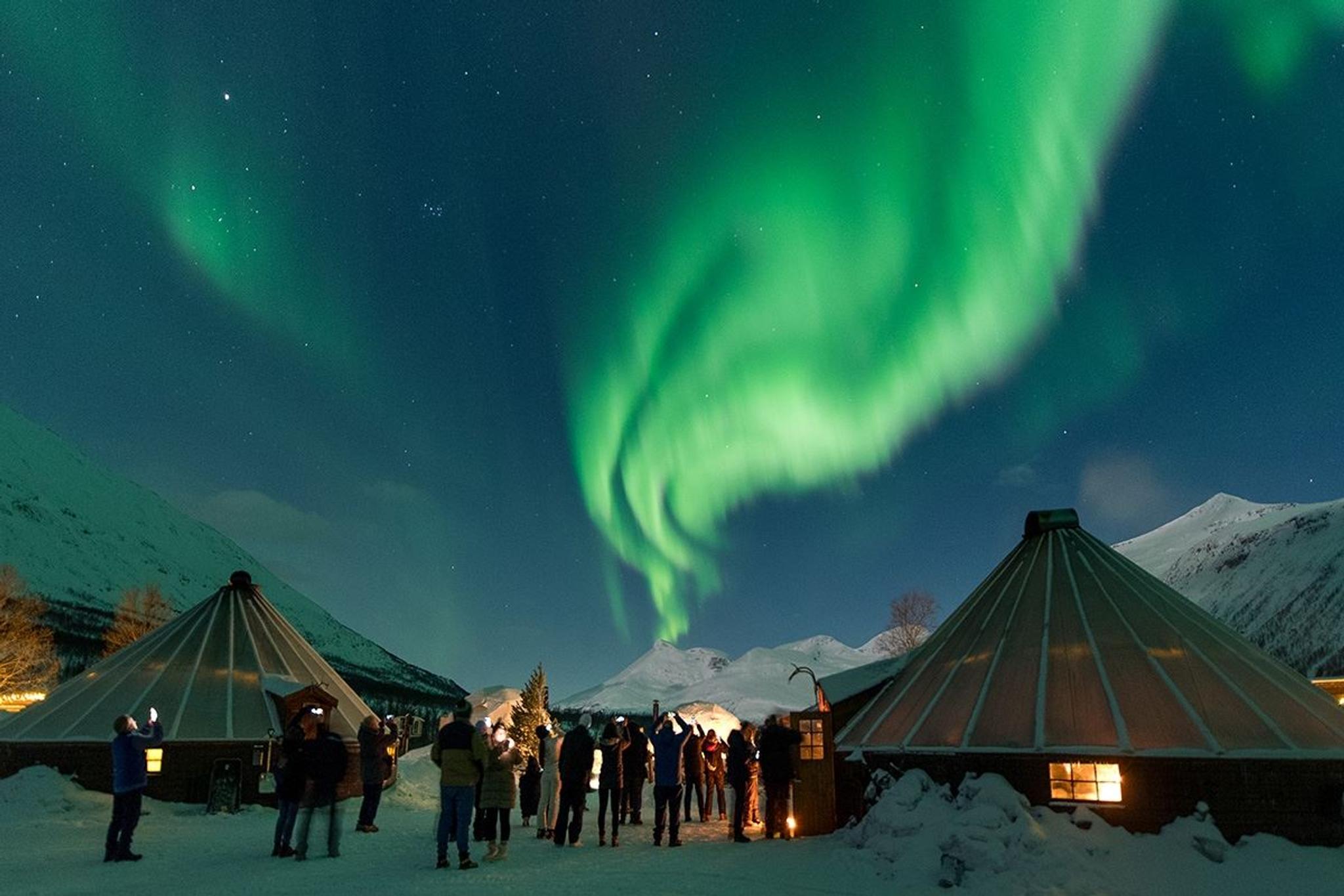 The Northern Lights shine over the camp