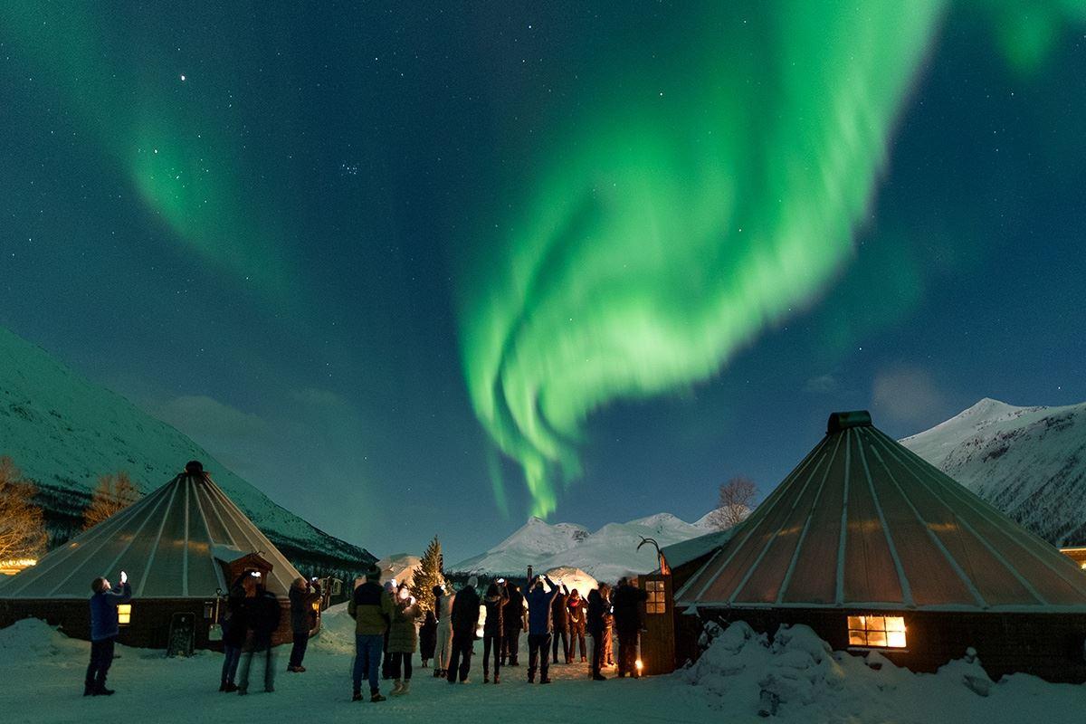 The Northern Lights shine over the camp