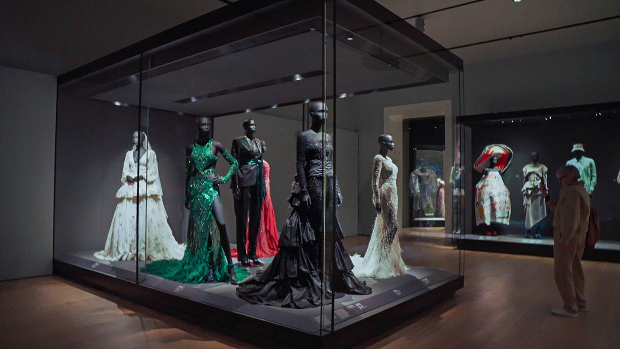 Dresses on display in an exhibition.