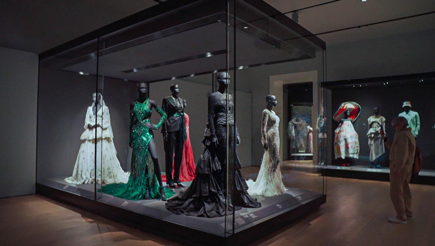 Dresses on display in an exhibition.