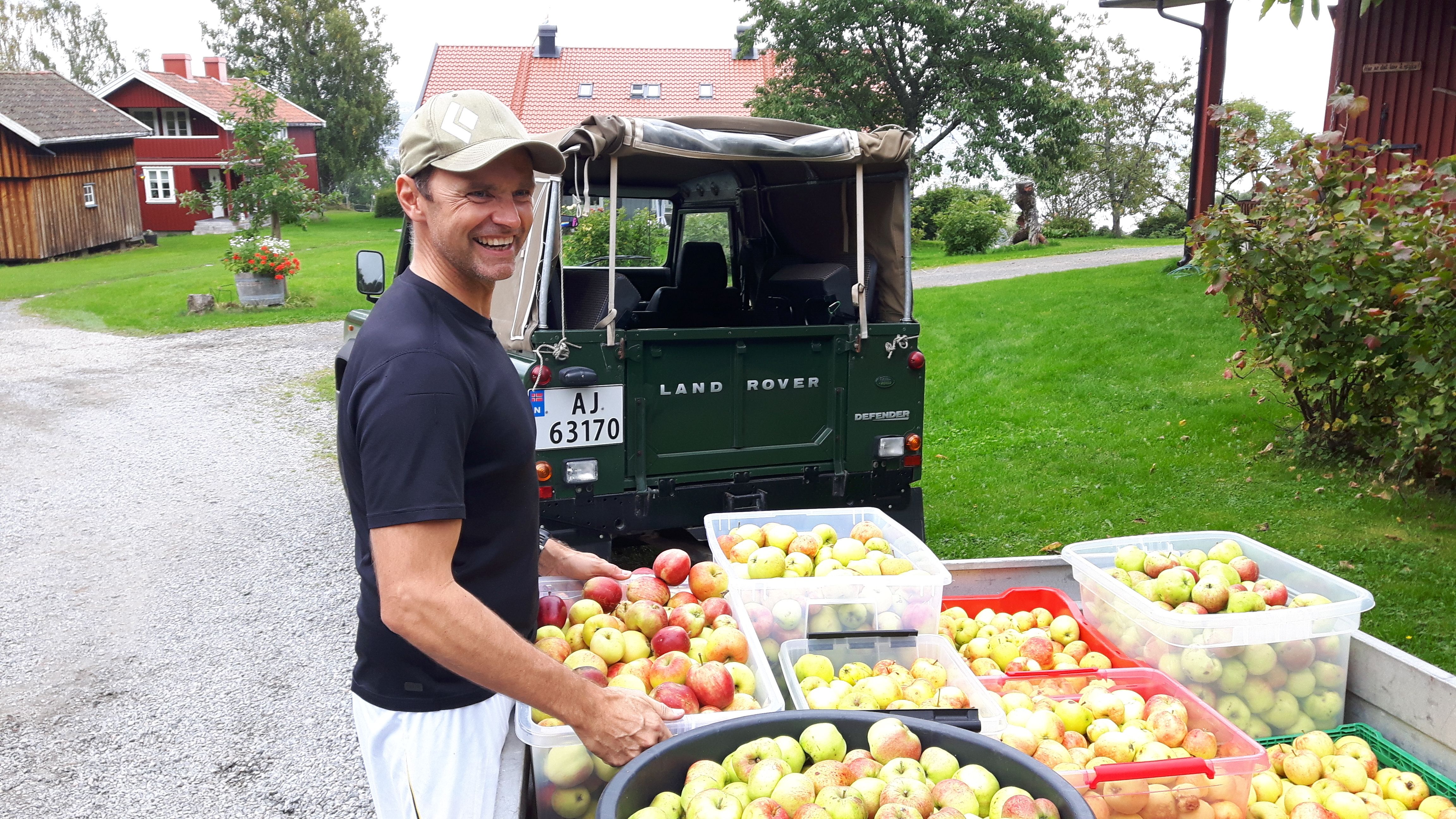 Farmer with cases of apples