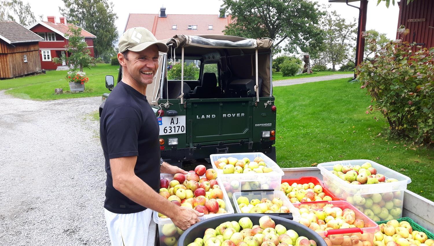 Farmer with cases of apples