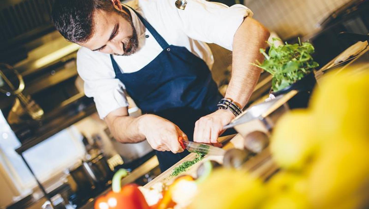 A skilled chef prepares delicious dishes using fresh, local ingredients at Tyssedal Hotel.