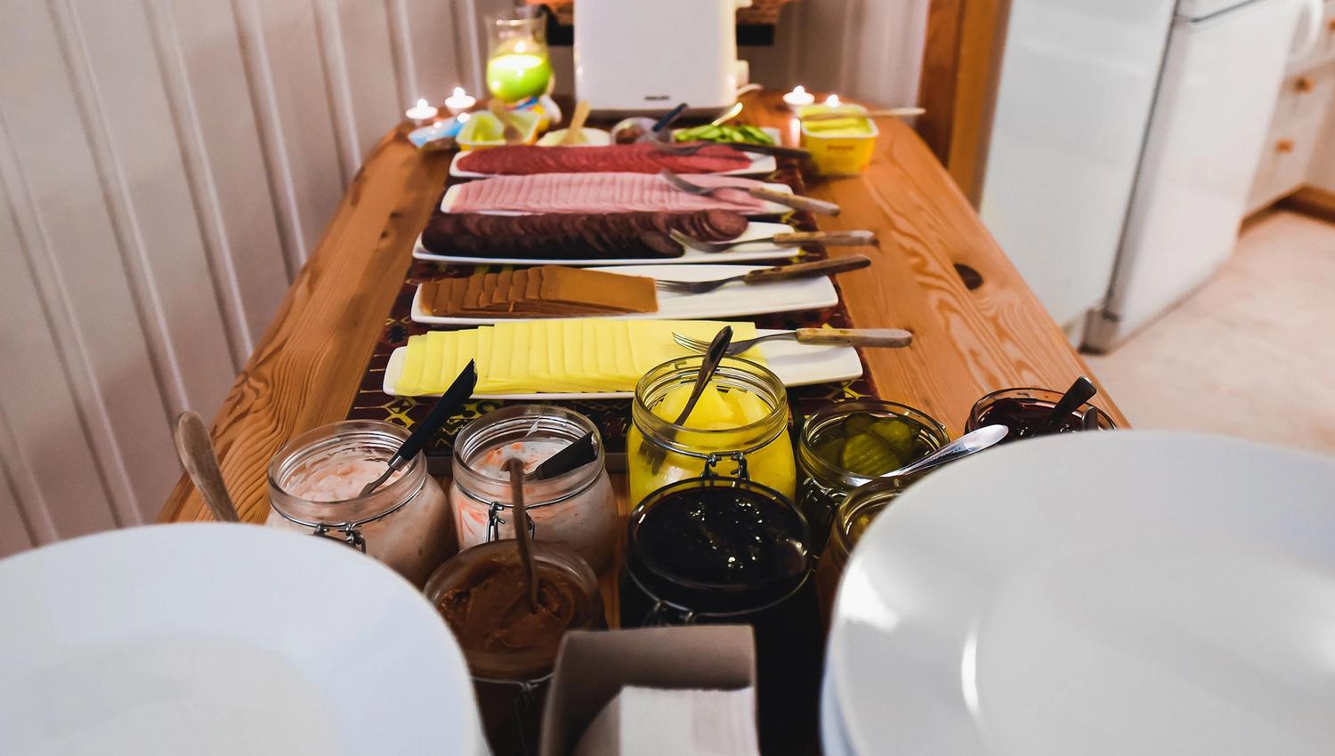 A breakfast buffet with food and plates