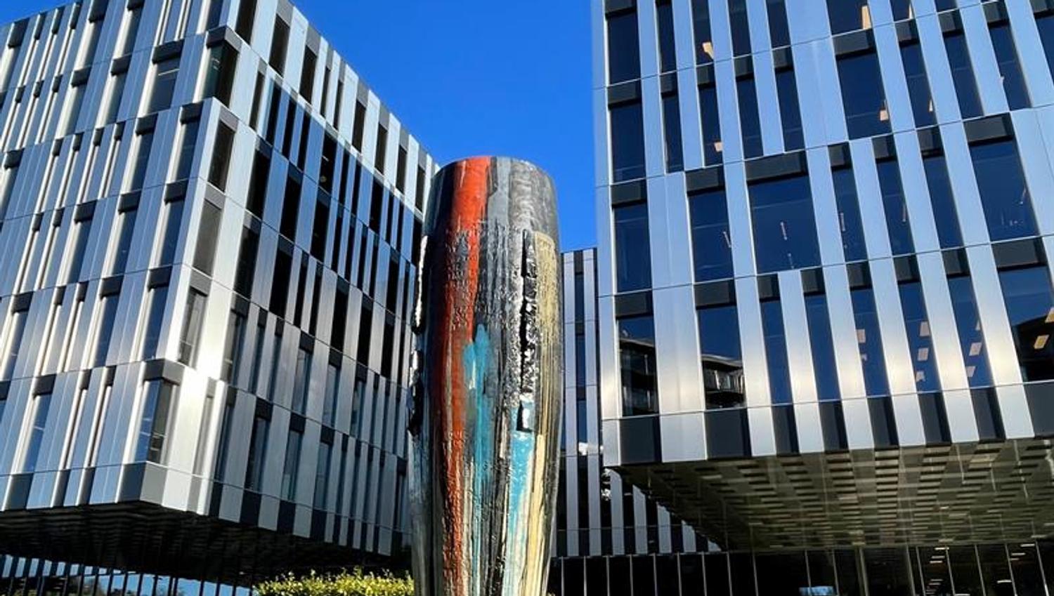 Ceramic vase in front of black and white building