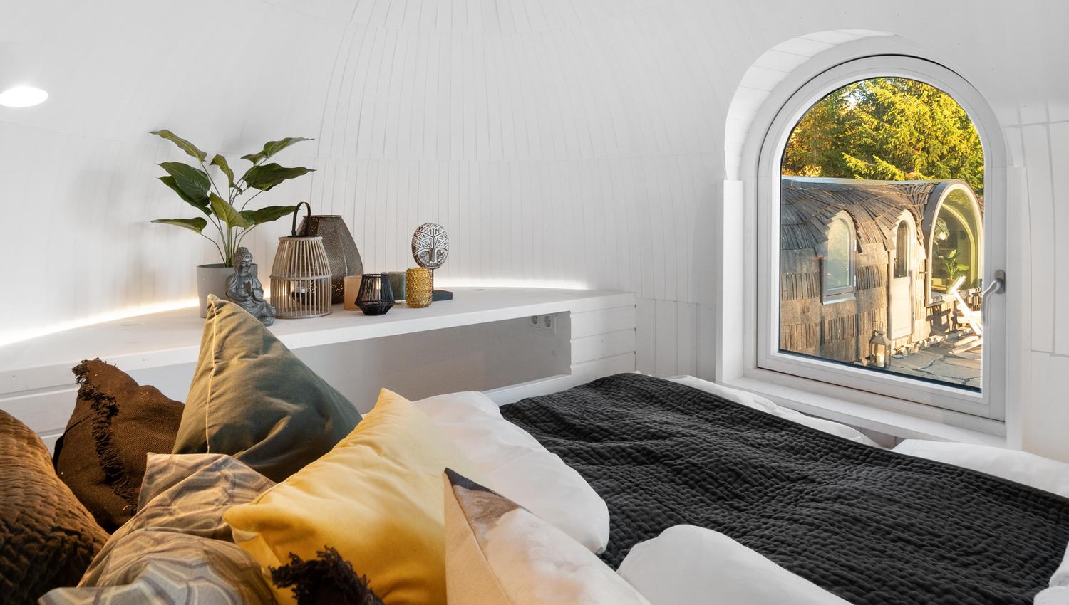 bed with pillows and a window