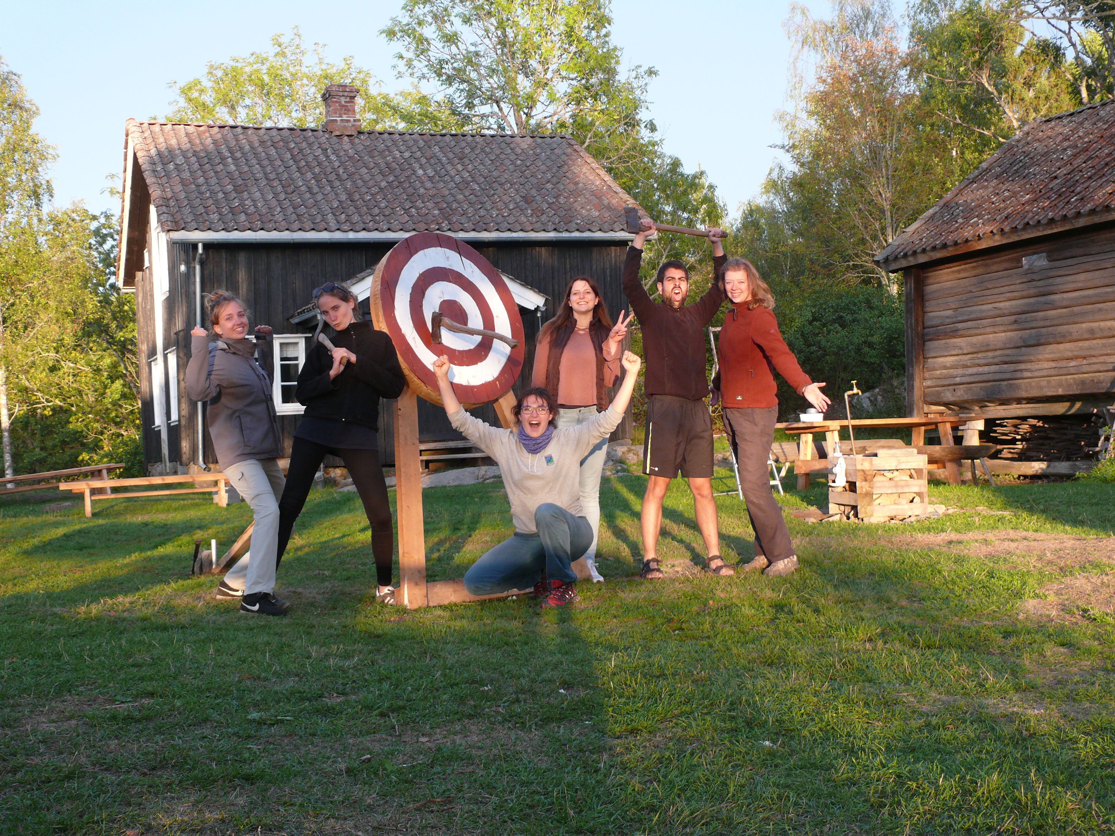 people in front of a throwing axe target
