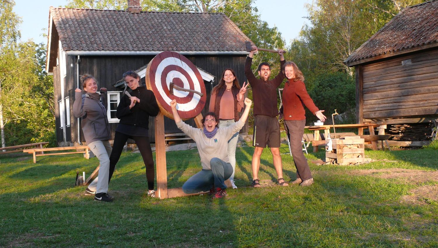 people in front of a throwing axe target