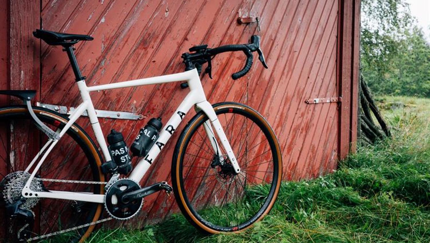 A bicycle leaning against a barn door