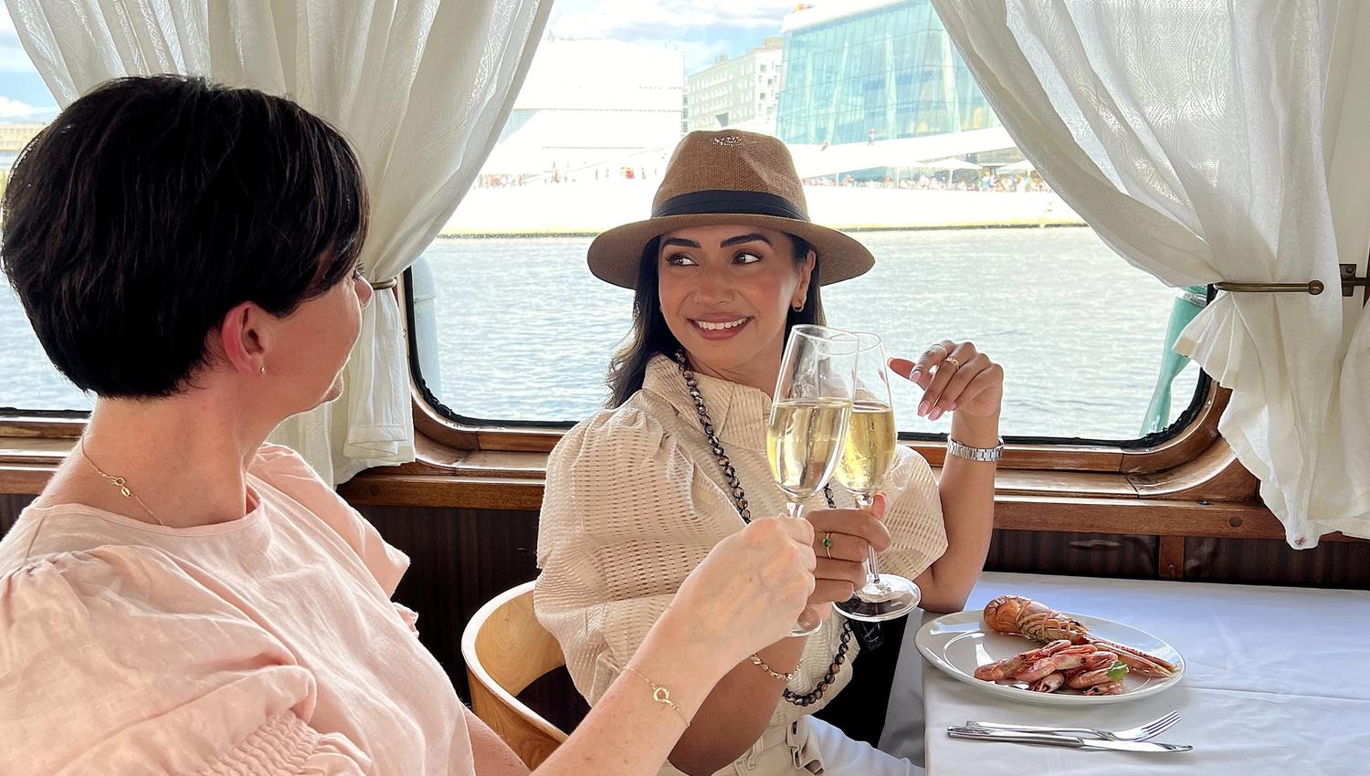 Two ladies enjoying brunch on the boat in front of the Opera