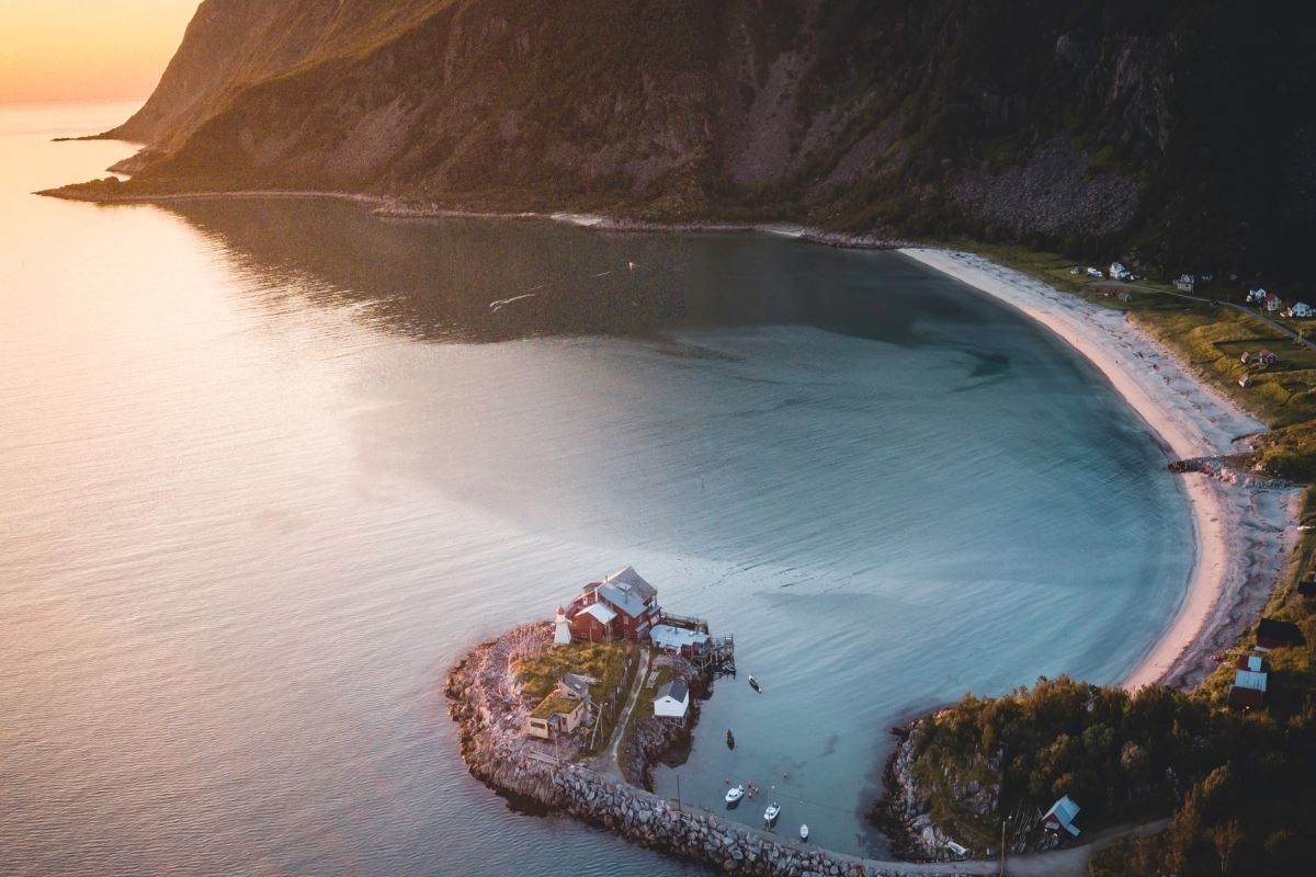 The view over the sea, the beach and a small island with a house on it