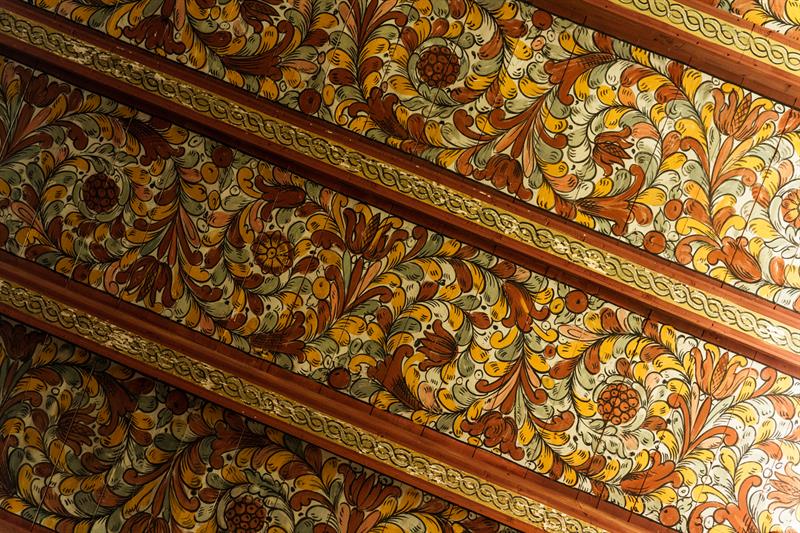 Colorful painted ceiling patterns in Røldal Stave Church, a masterpiece of Norwegian folk art.