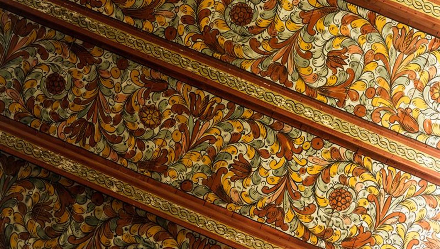 Colorful painted ceiling patterns in Røldal Stave Church, a masterpiece of Norwegian folk art.
