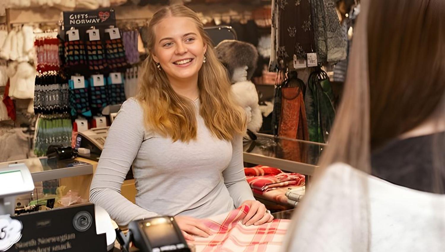 Customer purchasing a shawl at Tromsø Gift & Souvenir Shop