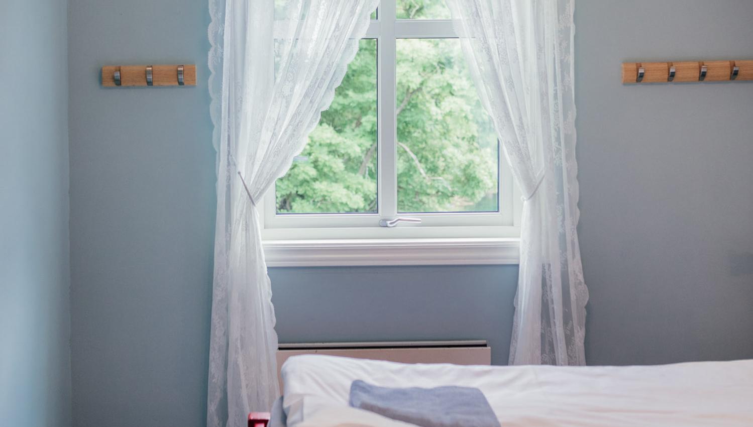 Bright and peaceful bedroom at Stana Farm – inspired by the colors of Norwegian nature and the fjord.