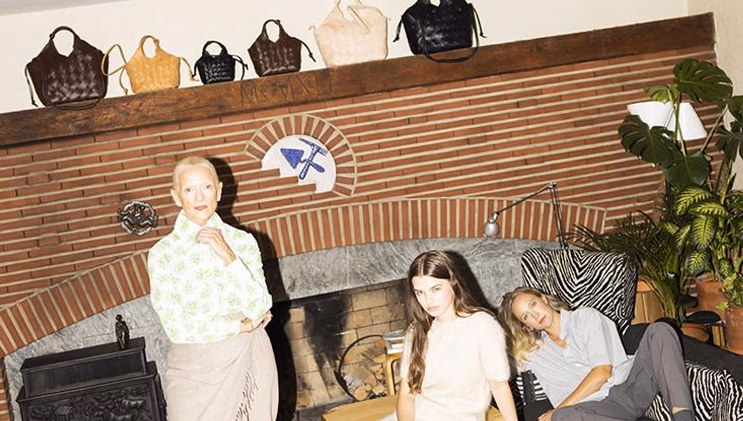 Bags on mantelpiece above three people.