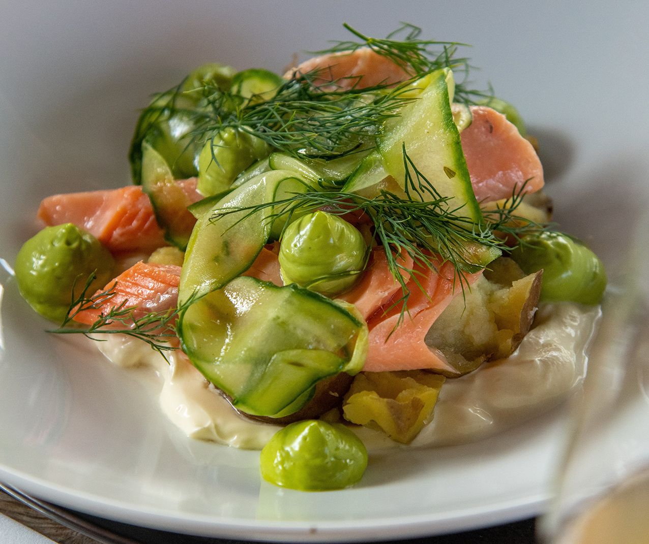 Local salmon dish with potatoes and fresh herbs served at Eldhuset Farm Restaurant.