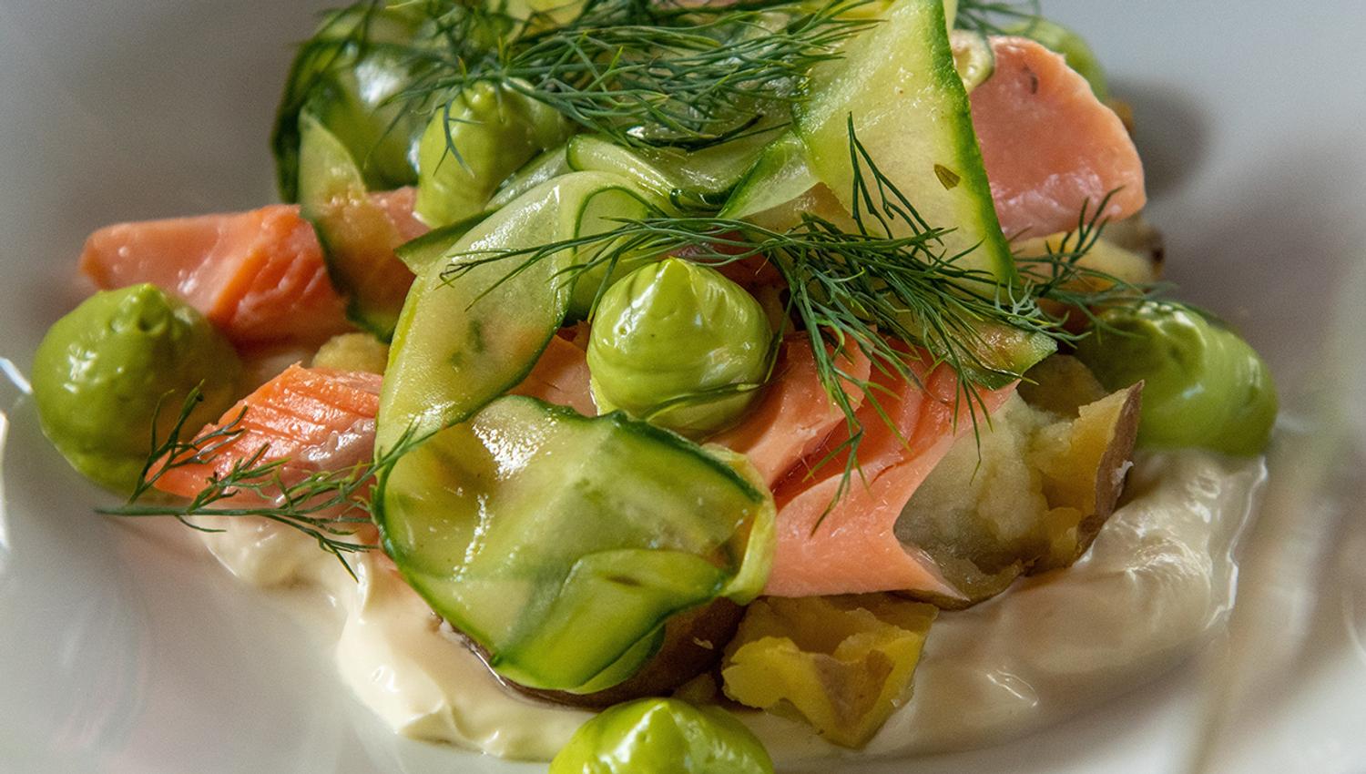 Local salmon dish with potatoes and fresh herbs served at Eldhuset Farm Restaurant.