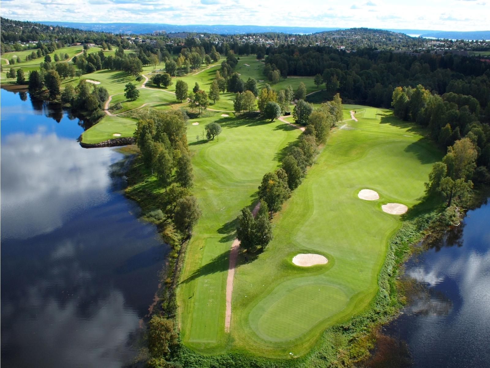 aerial view of the golf course surrounded by the fjord
