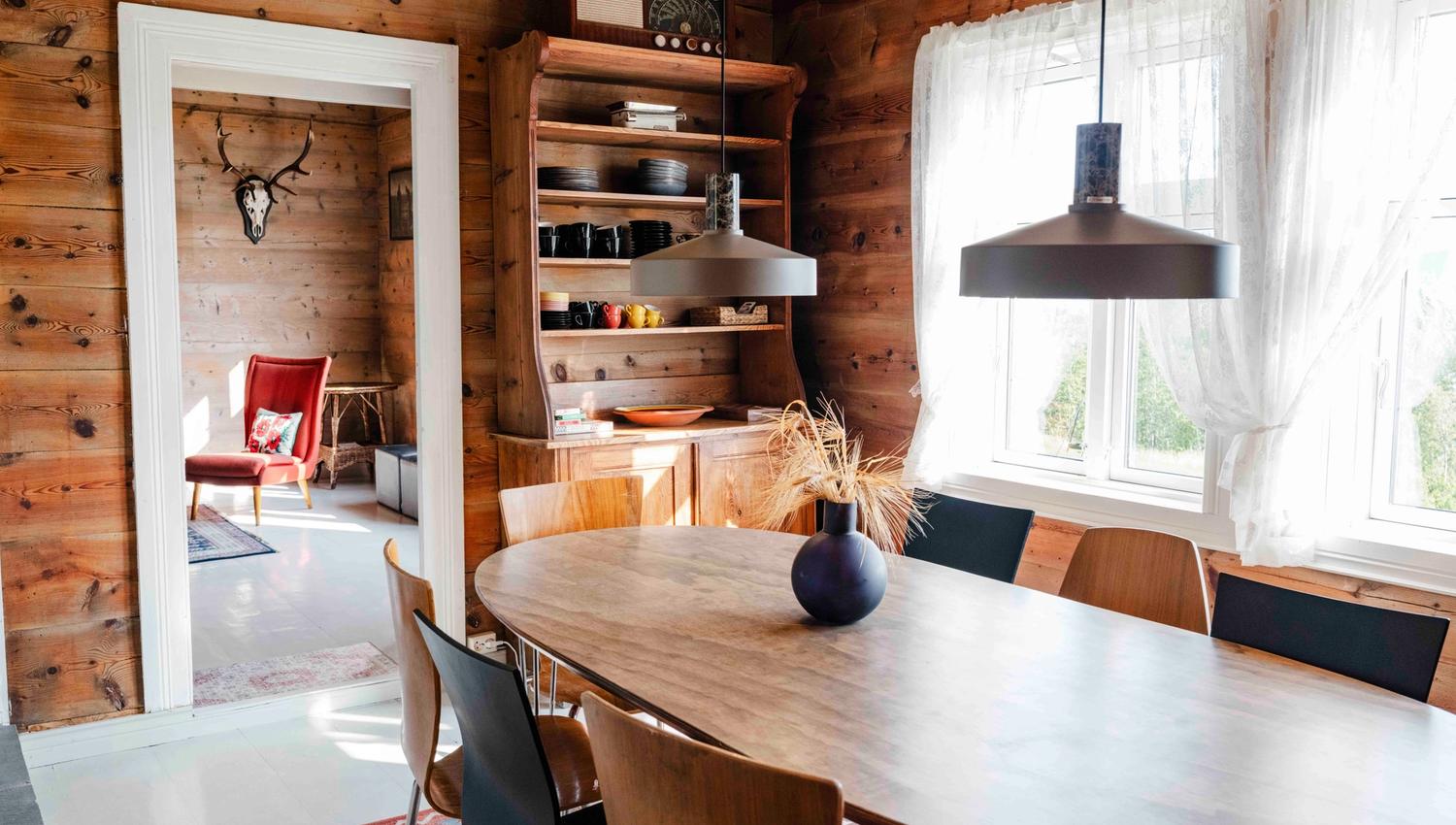 Spacious dining room with a scenic view and traditional charm at Stigen Fjordlodge.