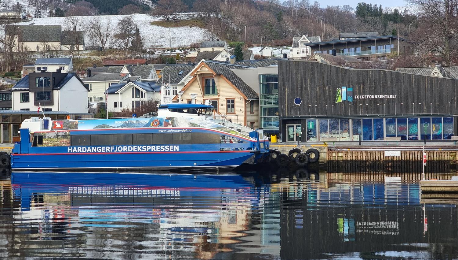 Hardangerfjordekspressen docked at a charming fjord town in Hardanger.