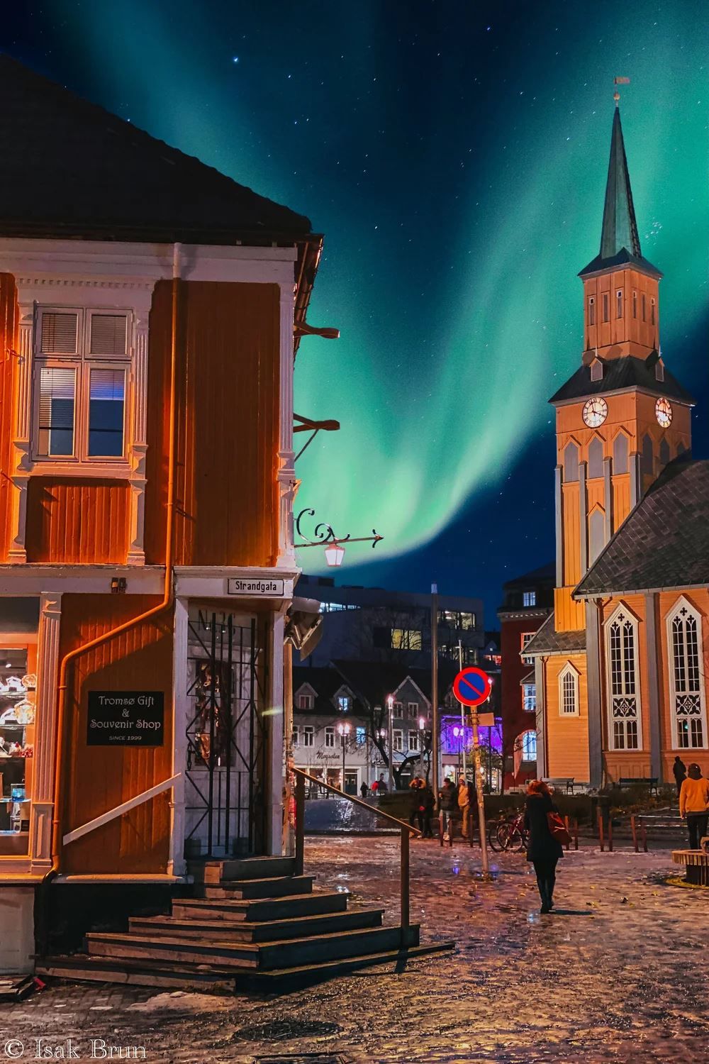 Northern lights above Tromsø Gift & Souvenir Shop with Tromsø Cathedral in the background.