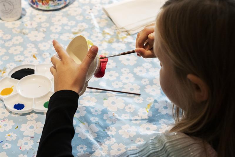 girl painting a cup at the porcelain museum in Porsgrunn