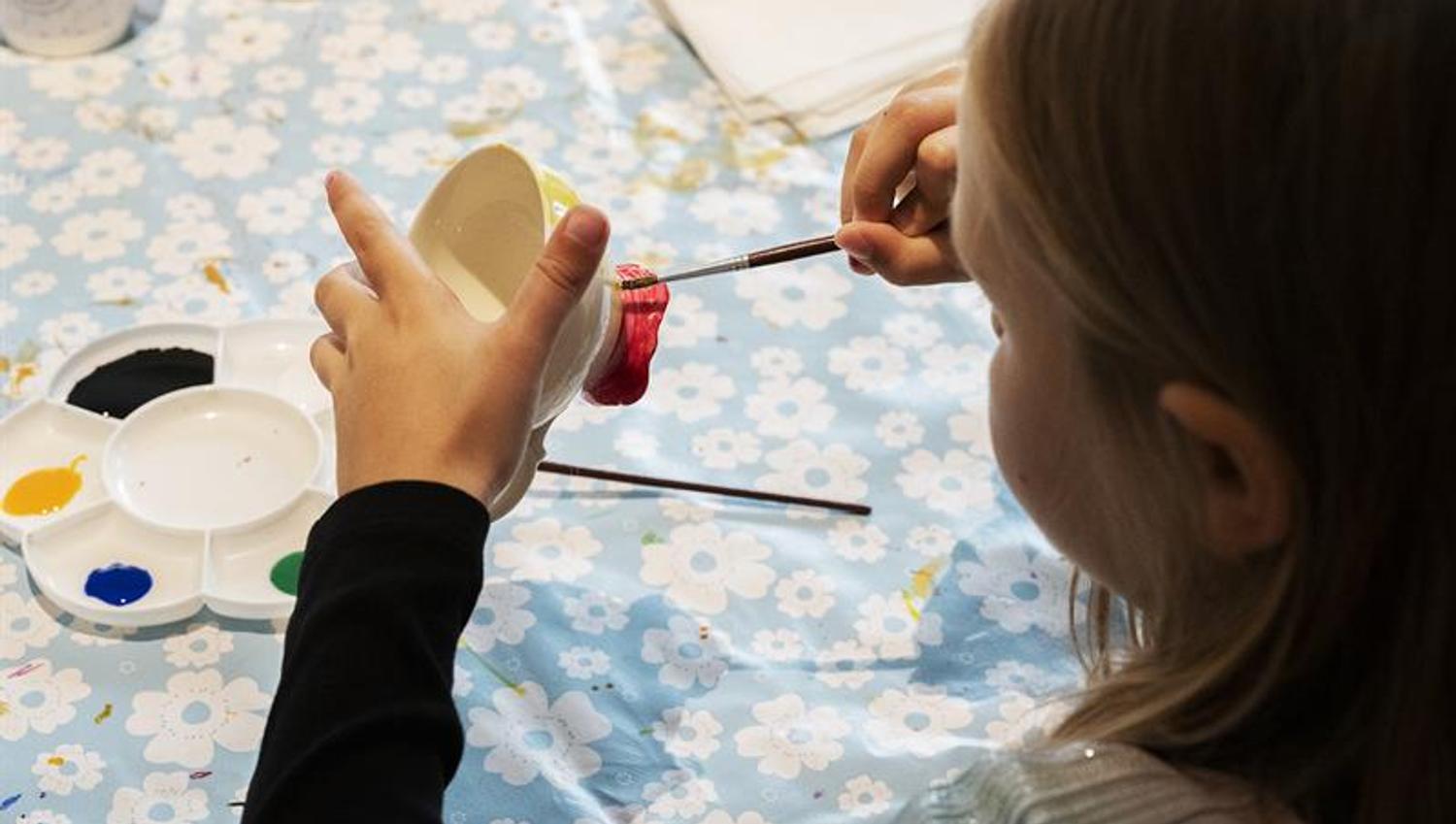 girl painting a cup at the porcelain museum in Porsgrunn