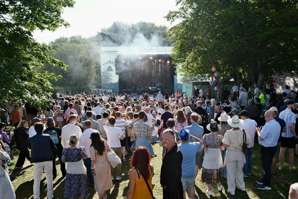 A concert stage in summer weather with an audience in front of it