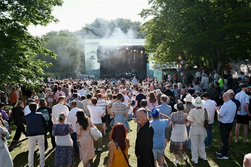 A concert stage in summer weather with an audience in front of it