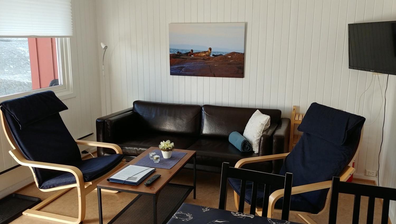 Living room with sofa, coffee table and armchairs