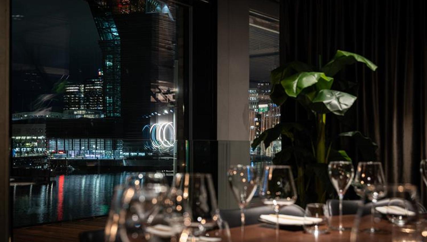 A table set for dining with a view of MUNCH in the background