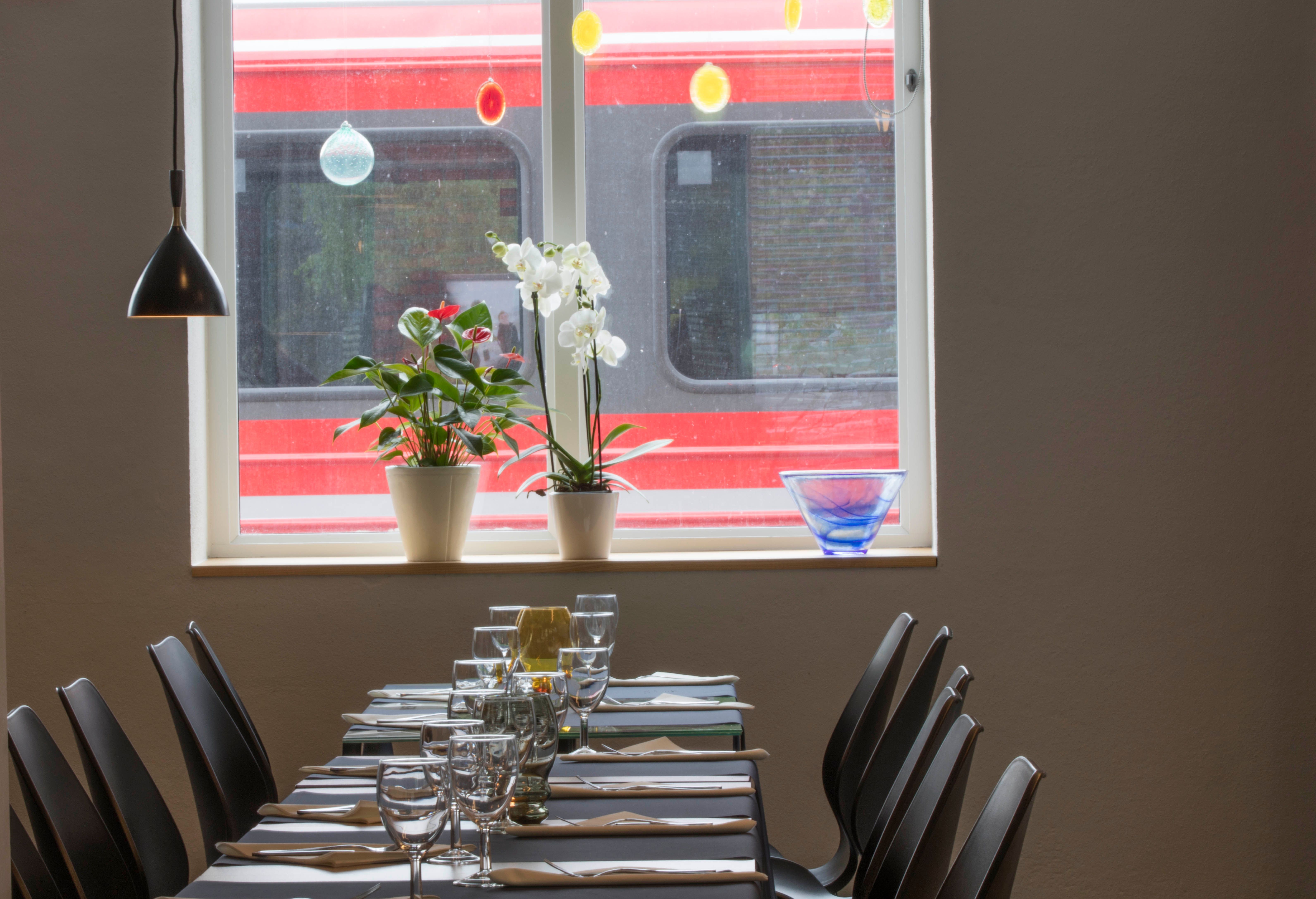 Long table set for customers at Stasjonen Cafe & Restaurant